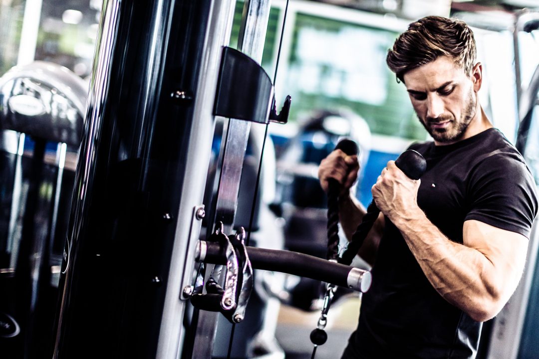Member training on the cable machine at the TMTC community gym
