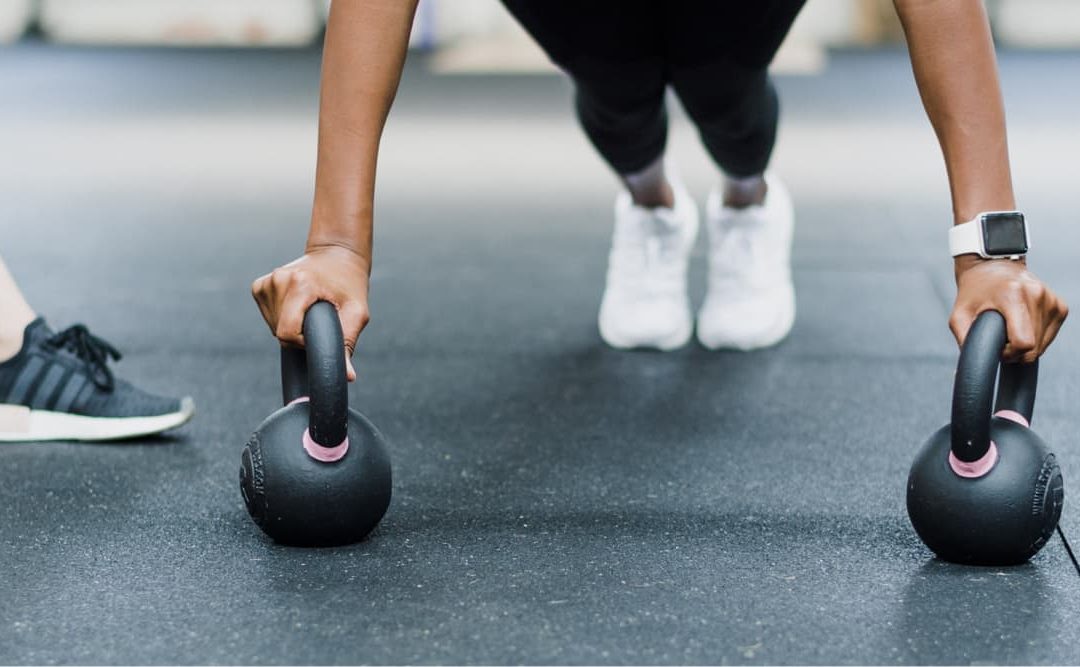 Member training with kettlebells at the gym